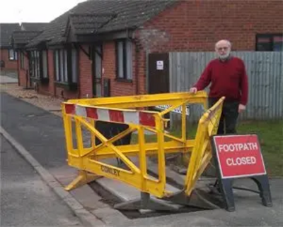 Bill Lewis inspecting repair at Mellish Court